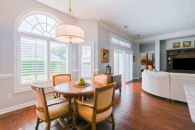 dining area featuring ornamental molding and dark hardwood / wood-style floors