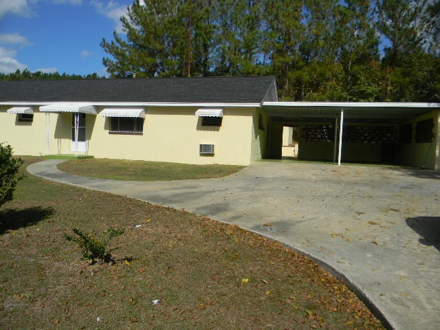 view of front of home with a carport