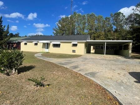 ranch-style home with a carport