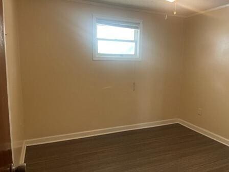 unfurnished room with dark hardwood / wood-style flooring