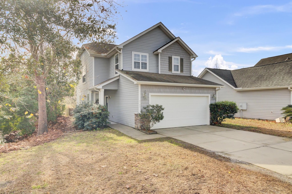 view of front of house featuring a garage and a front yard