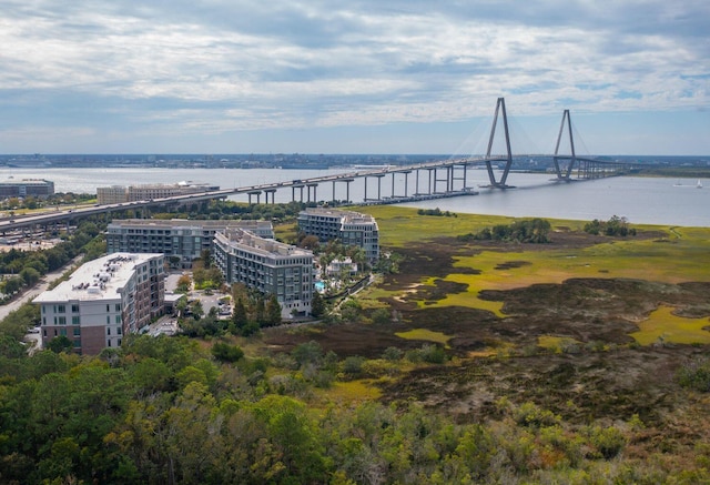 birds eye view of property featuring a pier, a water view, and a city view