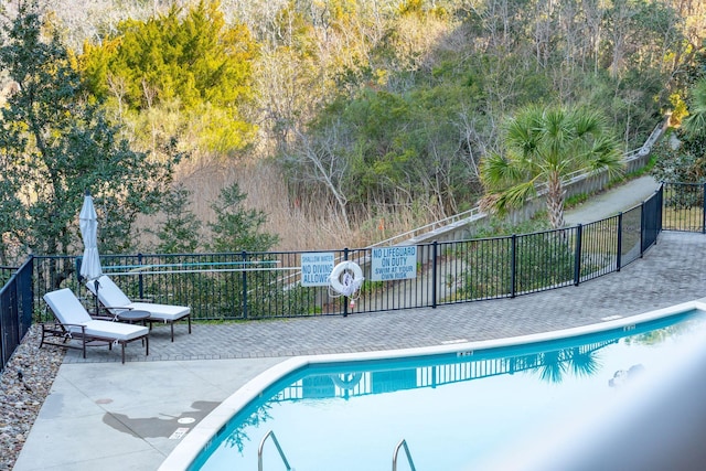 pool featuring a patio area and fence