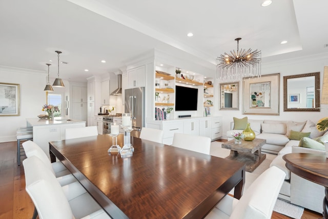 dining room with ornamental molding, recessed lighting, and wood finished floors