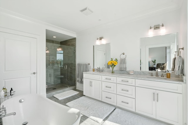 full bath featuring a stall shower, a soaking tub, a sink, and visible vents