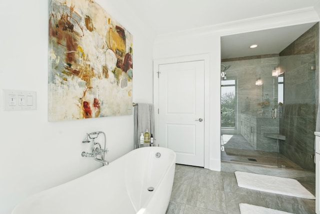 bathroom featuring a freestanding tub and a shower stall