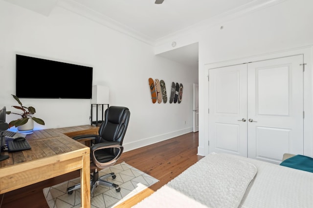 office area featuring baseboards, wood finished floors, and crown molding