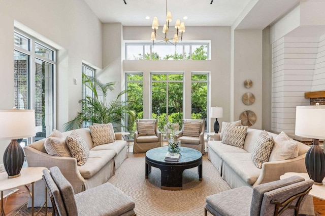 sunroom featuring a wealth of natural light and an inviting chandelier