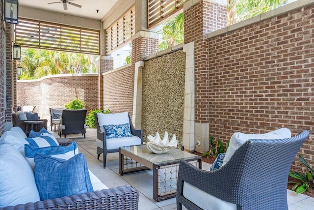 view of patio / terrace with a ceiling fan, fence, and an outdoor living space