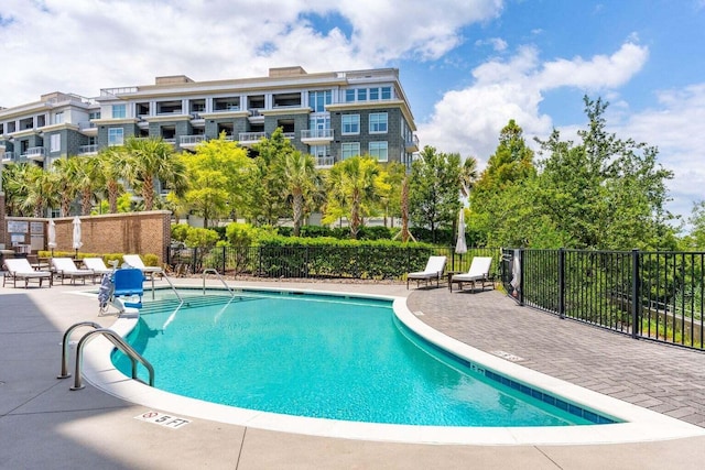 pool with fence and a patio