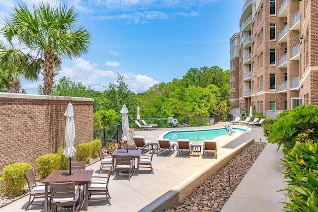 pool with fence and a patio