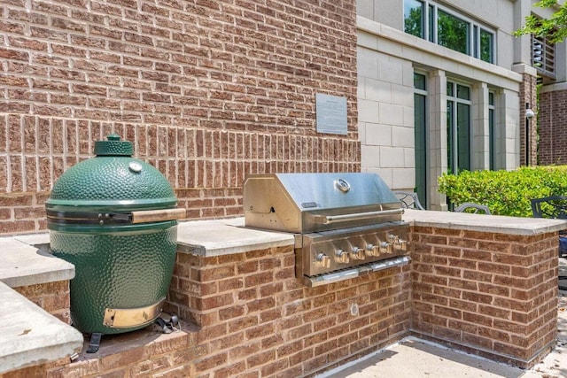 view of patio featuring an outdoor kitchen and a grill