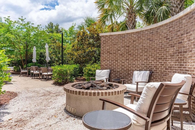 view of patio / terrace with a fire pit and outdoor dining space