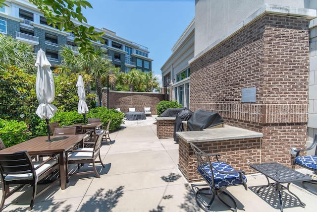 view of patio with an outdoor kitchen and outdoor dining space