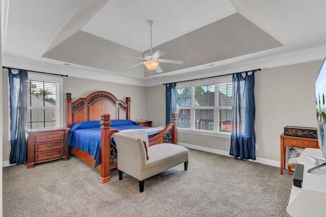 bedroom with ceiling fan, a raised ceiling, light carpet, and crown molding