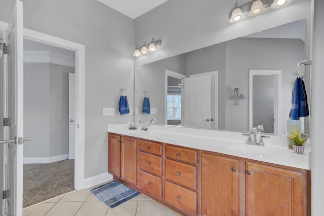 bathroom with tile patterned flooring, vanity, and crown molding