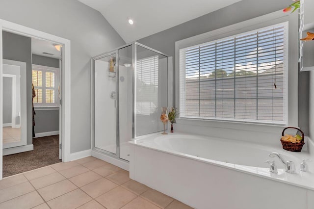 bathroom with tile patterned floors, lofted ceiling, and shower with separate bathtub