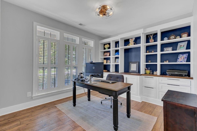 office with light wood-type flooring