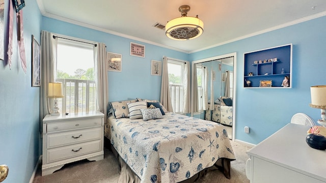 bedroom featuring carpet floors, ornamental molding, baseboards, a closet, and a ceiling fan