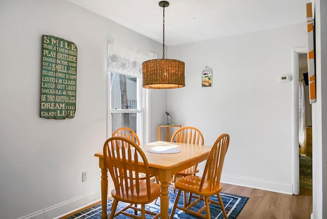 dining area featuring baseboards and wood finished floors