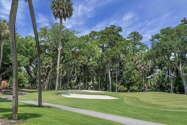 surrounding community featuring a yard and golf course view