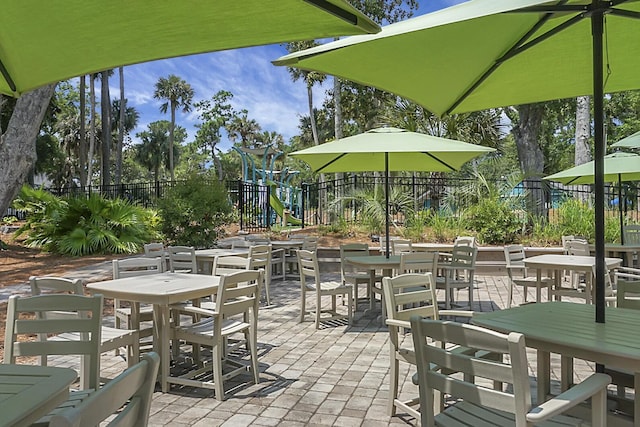 view of patio / terrace with playground community and fence