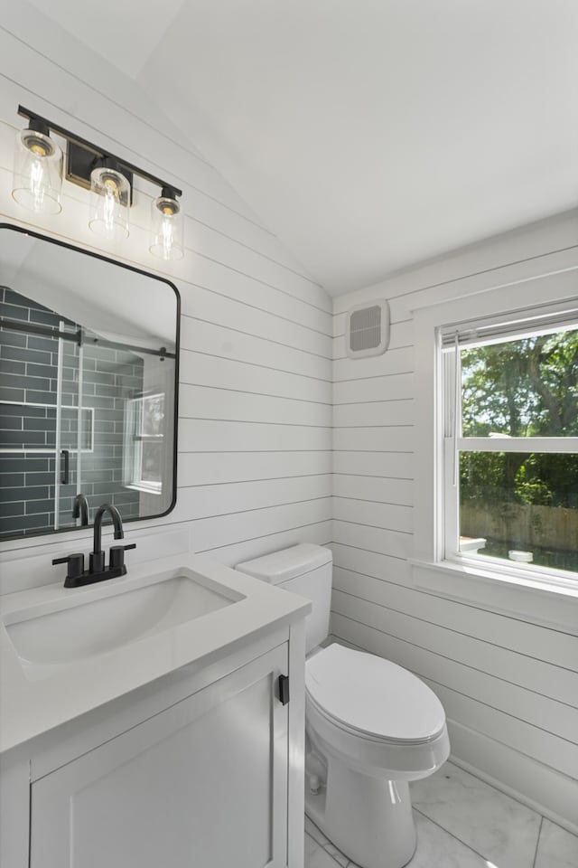 full bath featuring vanity, a shower with door, marble finish floor, lofted ceiling, and toilet