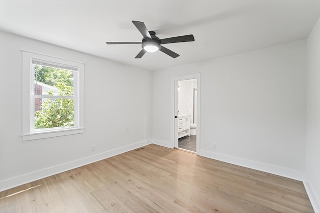 spare room with a ceiling fan, baseboards, and light wood-type flooring