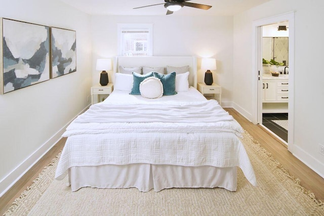 bedroom featuring baseboards, ceiling fan, wood finished floors, and connected bathroom