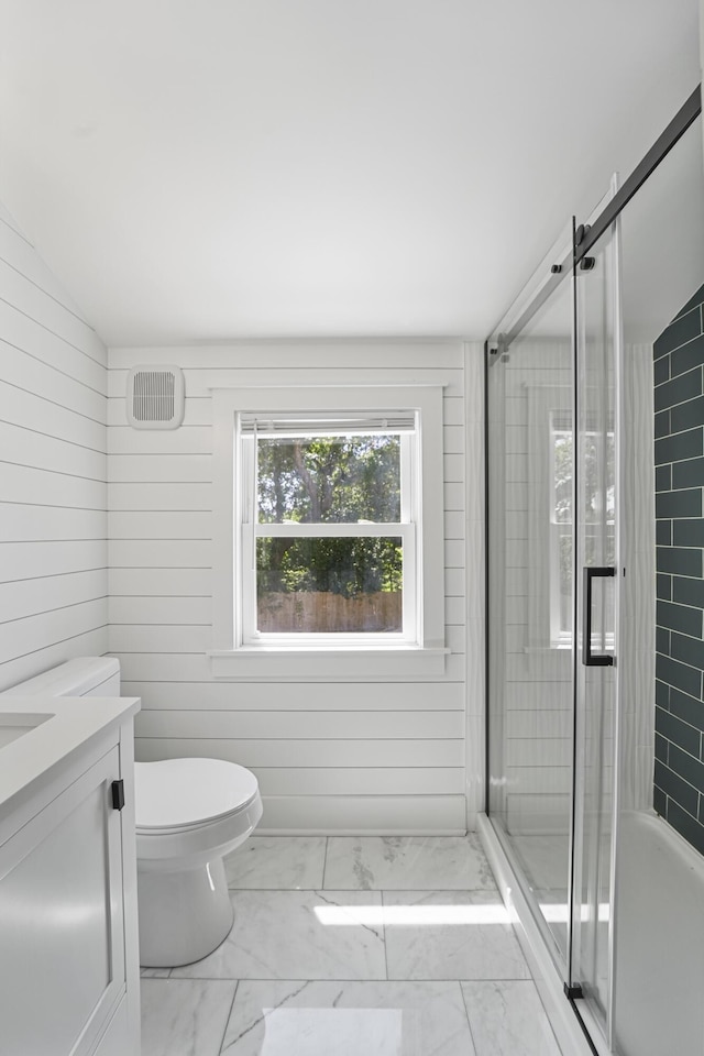 full bath with an enclosed shower, vanity, toilet, and marble finish floor