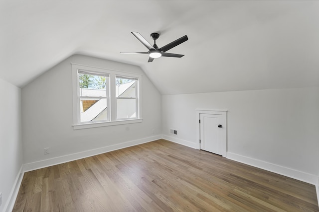 bonus room featuring a ceiling fan, baseboards, wood finished floors, vaulted ceiling, and visible vents