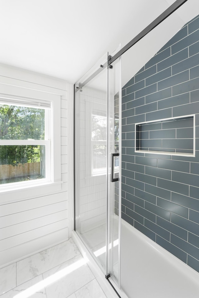 full bathroom with vaulted ceiling, a shower stall, and marble finish floor