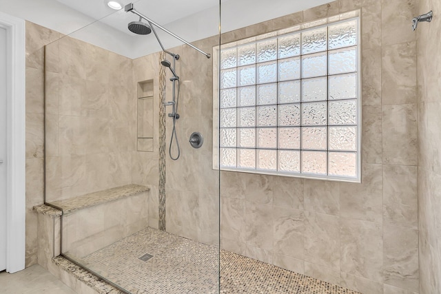 bathroom with tiled shower