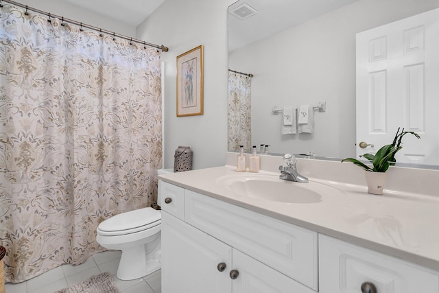 bathroom featuring tile patterned flooring, vanity, and toilet