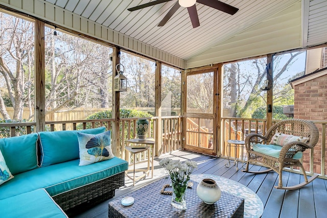 sunroom / solarium with vaulted ceiling, wood ceiling, and ceiling fan