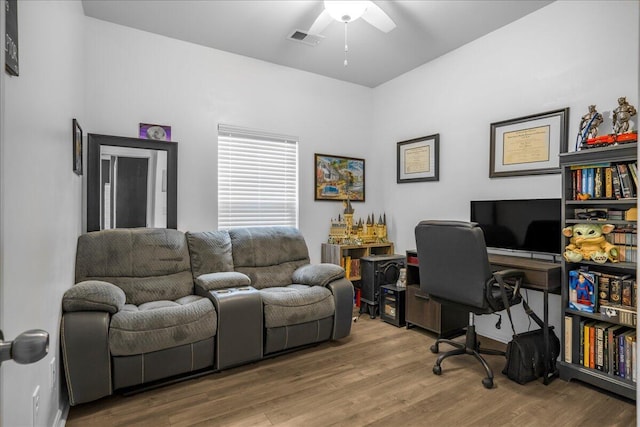 home office featuring wood-type flooring and ceiling fan