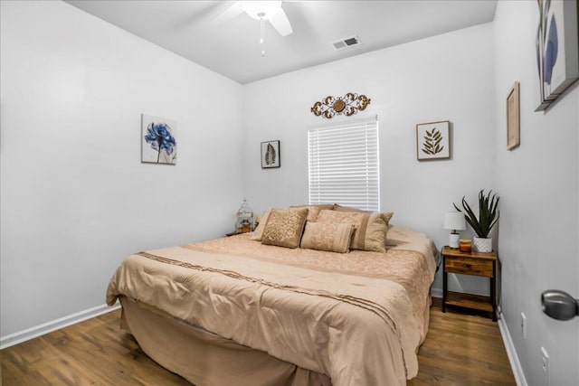 bedroom with ceiling fan and dark hardwood / wood-style floors