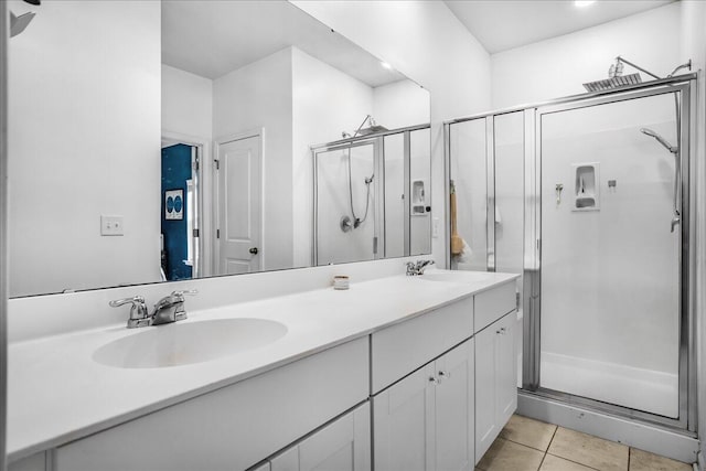 bathroom with tile patterned flooring, vanity, and a shower with shower door