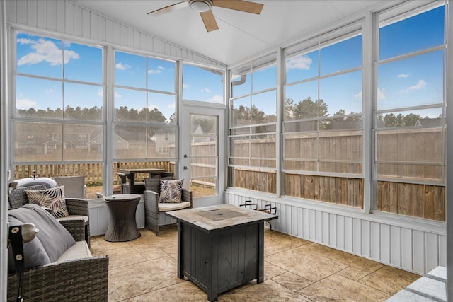 sunroom / solarium with ceiling fan and lofted ceiling