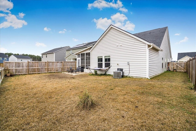 back of house featuring a lawn, a patio area, and central air condition unit