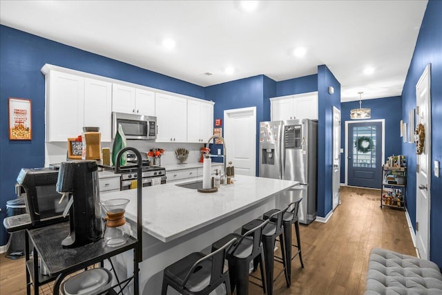 kitchen with white cabinets, stainless steel appliances, dark hardwood / wood-style floors, and sink