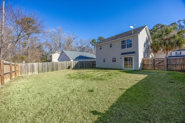 rear view of house with a lawn