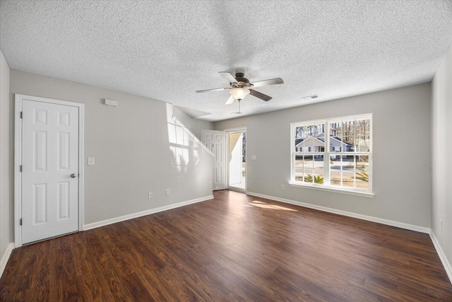 empty room featuring ceiling fan, a textured ceiling, and dark hardwood / wood-style floors