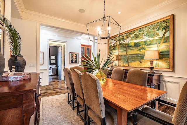 dining area with a chandelier, hardwood / wood-style floors, and ornamental molding