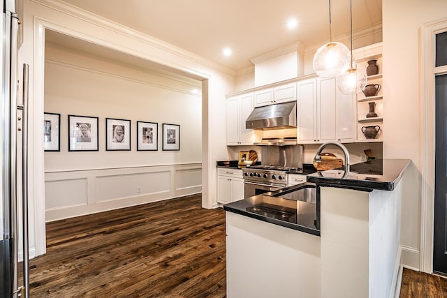 kitchen featuring pendant lighting, high end stove, white cabinetry, and ornamental molding