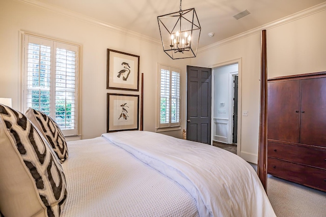 bedroom with multiple windows, crown molding, carpet, and a chandelier