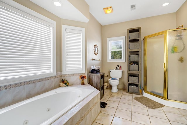 bathroom with tile patterned flooring, shower with separate bathtub, and toilet