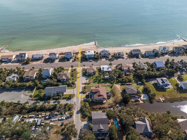 birds eye view of property featuring a water view and a beach view