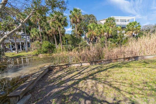 view of yard with a water view and a pergola