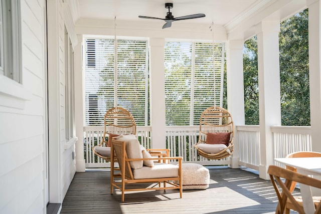 sunroom / solarium featuring ceiling fan